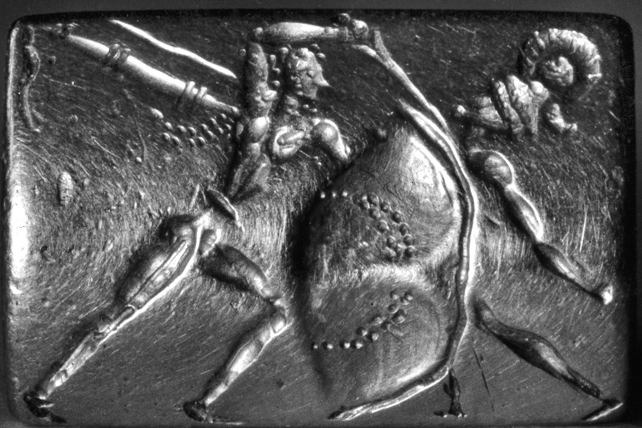 Siegel aus dem Grab III im Gräberrund A von Mykene, 16. Jahrhundert v. Chr., Gold, Maße 1,8 cm x 1,2 cm, Athen, Archäologisches Nationalmuseum.<br>
Quelle: <a href="http://arachne.uni-koeln.de/item/marbilder/4377084">Arachne / Corpus der minoischen und mykenischen Siegel, Universität Heidelberg</a><br>
Lizenz: Urheberrechtlich geschütztes Werk
